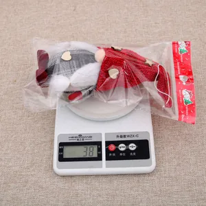 Detailed view of Christmas gnome plush doll weighing approximately 38g on scale