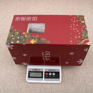 Detail showing 744g weight of the Christmas music box ornament in red gift box