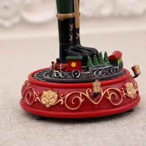Detail view of a Christmas Nutcracker music box featuring a rotating miniature train base