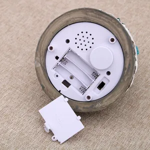 Bottom detail view of the musical house ornament showing battery compartment and switch