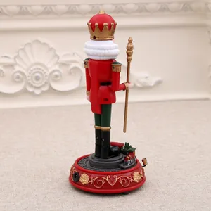 Detailed rear view of a rotating musical nutcracker soldier on a red decorative base
