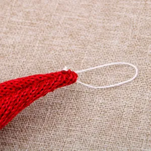 Macro view showing the texture of a red knitted Christmas hanging ornament with a loop