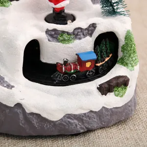 Detailed macro view of the rotating miniature train on a snowy Christmas music box.