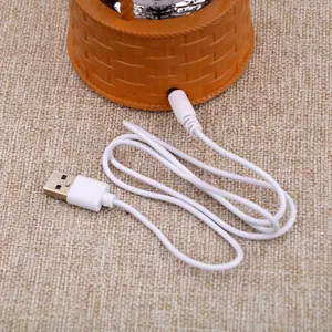 Detailed view of the white USB charging cable for the hot air balloon music box ornament
