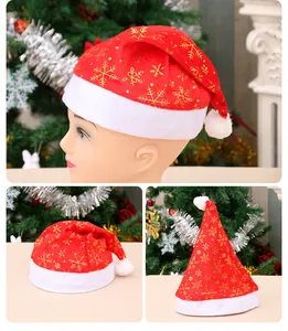 Detailed views of red Christmas hat with gold snowflake print and white plush trim.