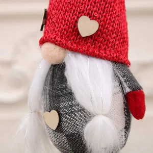 Detailed view of handmade Christmas gnome ornament with red knitted hat and white braids