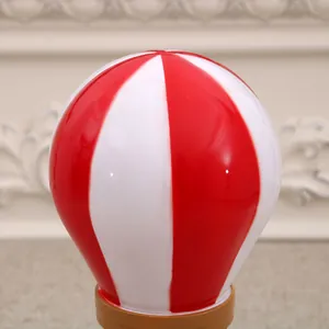 Close-up detail of a decorative red and white striped hot air balloon Christmas music box.