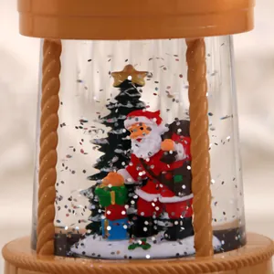 Detail view of Santa Claus and Christmas tree inside a festive music snow globe decoration