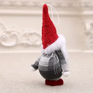Handcrafted plush Christmas gnome ornament with a red knitted hat and gray plaid body