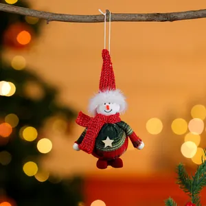 High-quality close-up of a festive plush snowman ornament hanging from a rustic branch