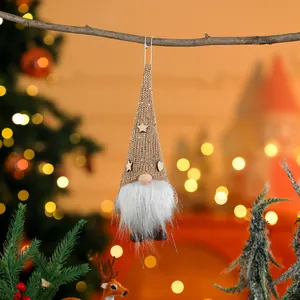 Detail view of a hanging Christmas gnome ornament with a white beard and knitted hat