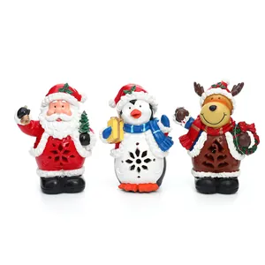 Set mit 3 leuchtenden Weihnachtsfiguren aus Harz: Weihnachtsmann, Pinguin, Rentier