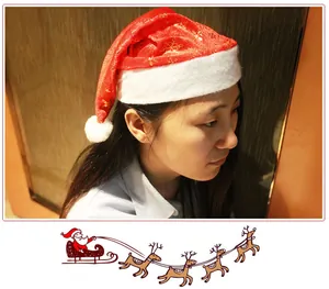 Side view of adult wearing red Christmas Santa hat with gold snowflake print