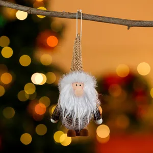 Charming fabric Christmas gnome ornament hanging on a branch with festive bokeh background