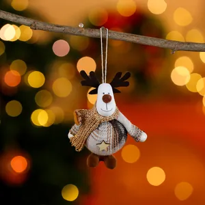 Plush reindeer Christmas ornament with plaid body and gold scarf hanging on a branch