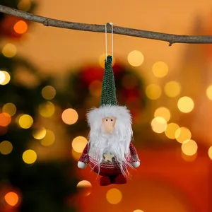 Detail shot of a plush Christmas elf ornament with green hat and white beard
