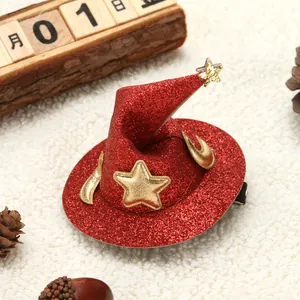 Detail of a red glitter witch hat hair clip with gold star and moon for Halloween.