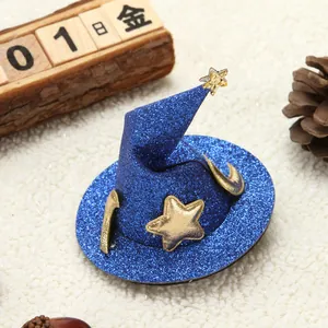 Close-up of a blue glitter witch hat hair clip decorated with gold stars for Halloween