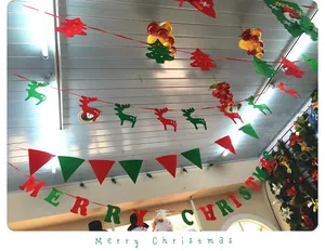 Detail view of red and green non-woven Christmas banner garlands on the ceiling