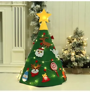 Detail view of DIY felt Christmas tree for kids decorated with warm LED fairy lights in room
