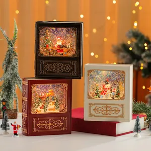 Palle di neve natalizie a forma di libro con scene luminose e glitter festivi