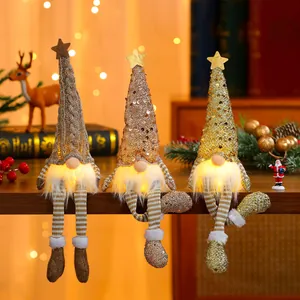 Detail showing glowing sequin Christmas gnomes with warm lights and long dangling legs