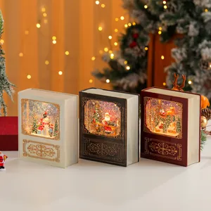 Tre palle di neve natalizie vintage a forma di libro con luci calde e glitter
