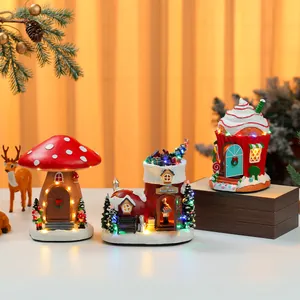 Detailed view of three festive LED light-up resin Christmas house ornaments for decor