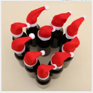 Mini red Christmas hats for wine bottle decoration arranged in a heart shape