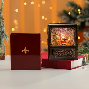 Dettaglio del carillon a palla di neve di Natale a forma di libro con Babbo Natale