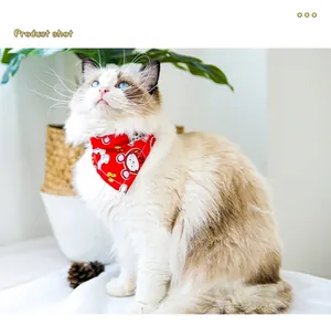Detailed view of a fluffy cat wearing a cute red cartoon patterned pet bandana collar