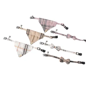 Selection of plaid pet collars with decorative bow ties, bandanas, and mini bells