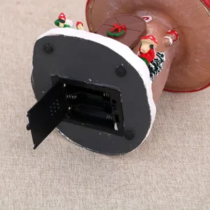 Detail view of the battery compartment on the bottom of the Christmas resin music box.