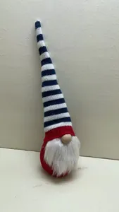 Detail view of a patriotic knit gnome with long blue and white striped hat.