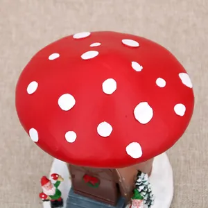 Close-up detail of a bright red polka dot mushroom house roof for a festive resin music box
