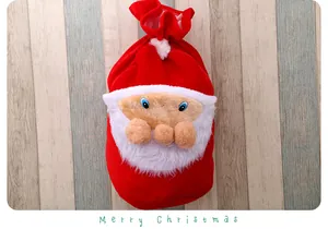 Vue détaillée d'un grand sac cadeau de Noël en velours avec un visage de Père Noël doux
