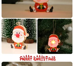Festive glowing wooden Santa Claus Christmas tree ornament with warm LED light detail