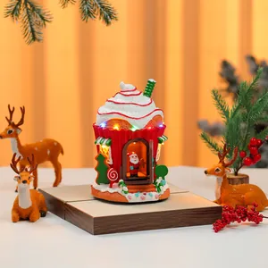 Detailed shot of a festive musical resin house with LED lights and Santa figurine.