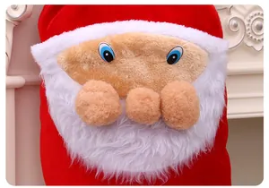 Gros plan du visage du Père Noël sur un sac cadeau et de bonbons festif en velours rouge