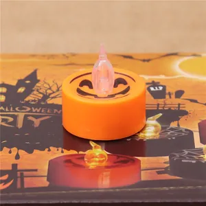 Detailed view of a smiling orange LED pumpkin tea light for Halloween party decor