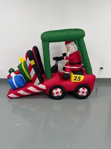 Large inflatable Santa Claus driving a red forklift carrying festive gift boxes