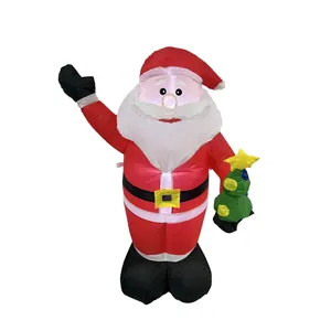 Outdoor inflatable Santa Claus holding a small Christmas tree for festive yard decoration
