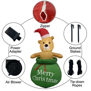 Ours de Noël gonflable dans un sac cadeau vert avec souffleur et kit de piquets