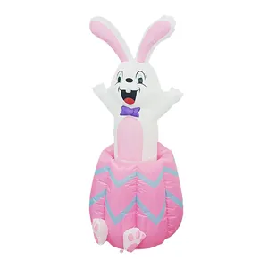 Detailed full view of an inflatable white Easter bunny jumping out of a pink egg