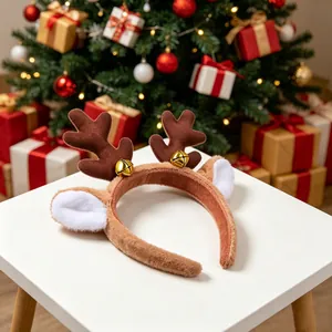 Diadema de cuernos de reno navideño en mesa blanca con fondo de árbol festivo.