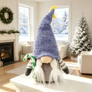Detail eines Weihnachtsgnom-Plüschtiers mit blauem Strickhut und Mond-Ornament.