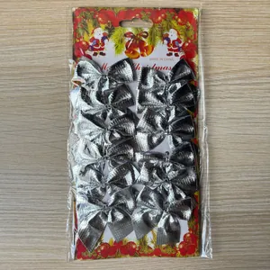 Close-up of 12 silver textured Christmas bows in festive retail packaging for DIY decor.