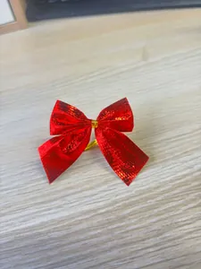 Close-up of a shiny red metallic Christmas bow tie decoration for festive DIY crafts