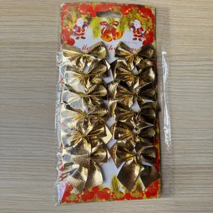 Pack of 12 gold mini metallic Christmas bows in retail packaging for tree decoration
