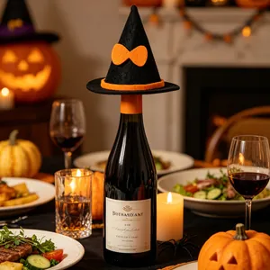Detail shot of a mini black witch hat with orange bow used as a festive wine bottle topper.